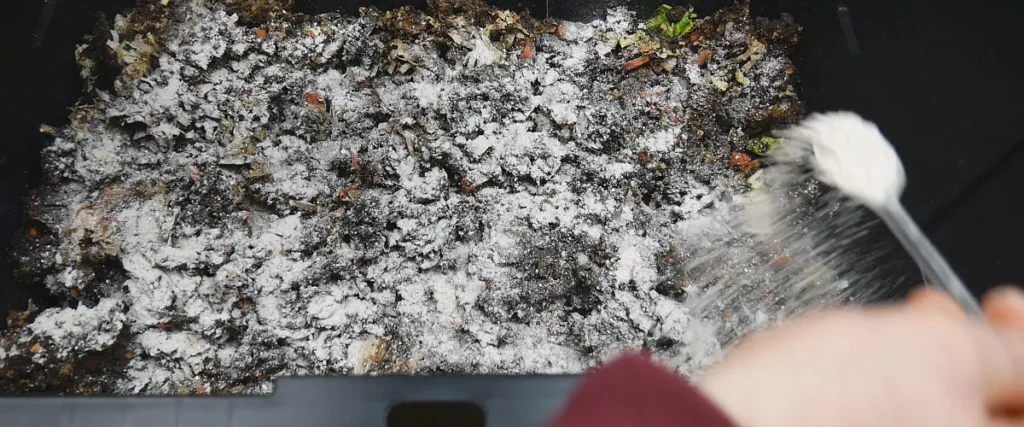 sprinkling ground up egg shells into worm bin